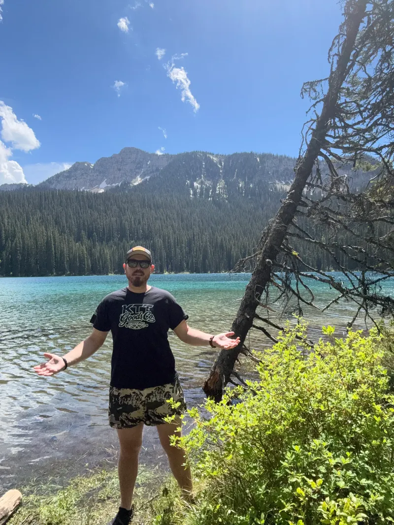 Cody wearing KTT Goods Co. apparel beside a Northwest Montana lake