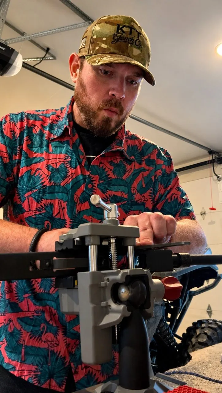 Cody Rhoads working with a bench fixture in his garage