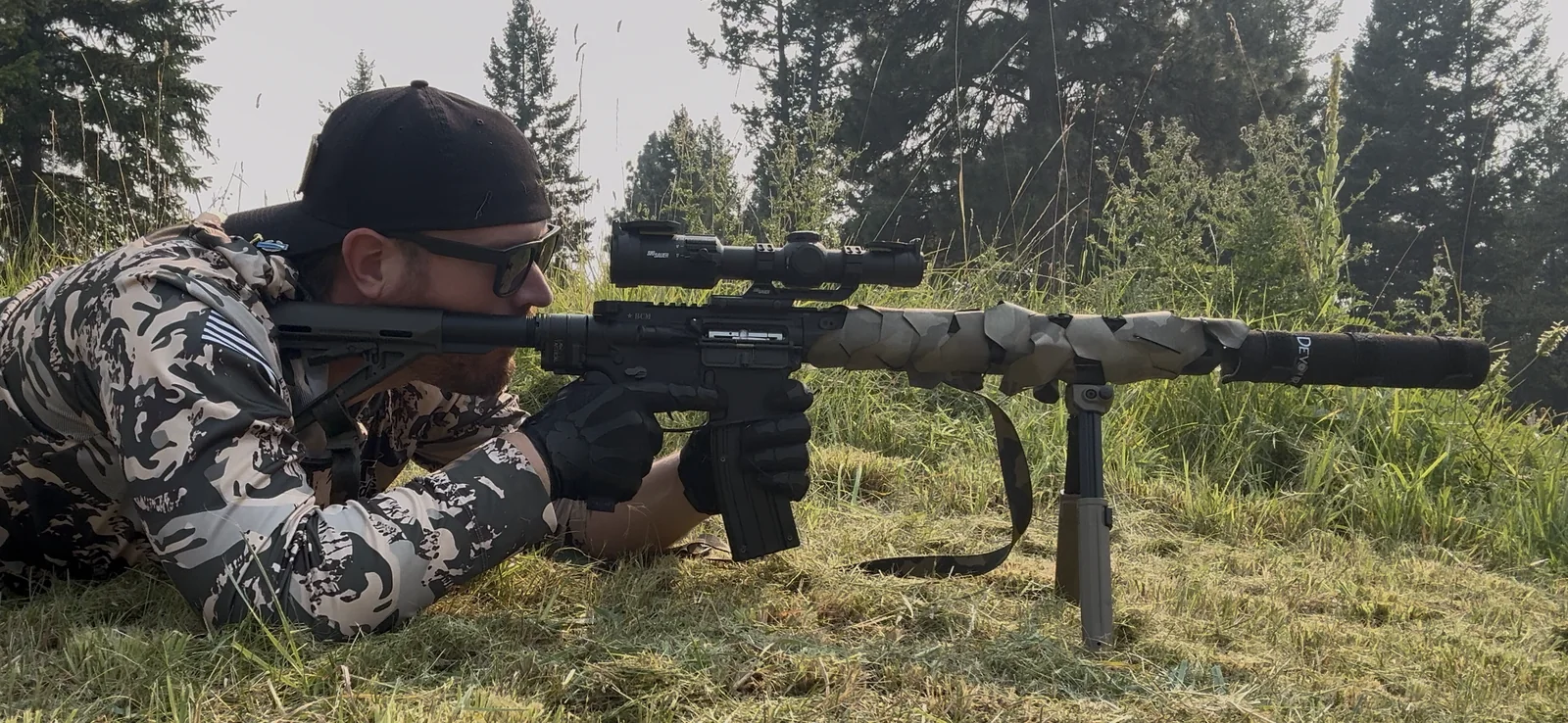 Cody Rhoads testing TV-D1 camouflage from a prone field position in Northwest Montana