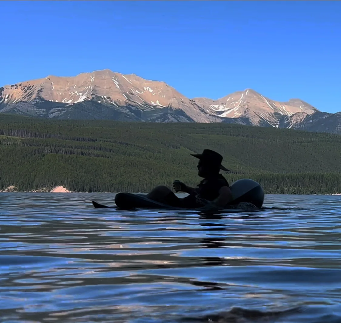 Lake with mountains and a person on the water