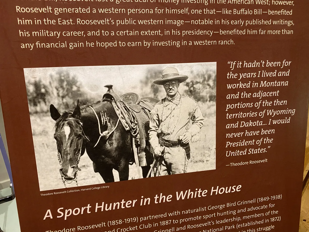Museum panel with Theodore Roosevelt beside a saddled horse and a Montana quote